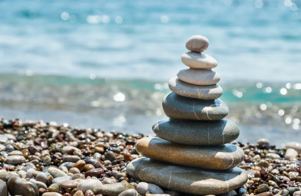 A cairn of balanced stones on a pebble beach