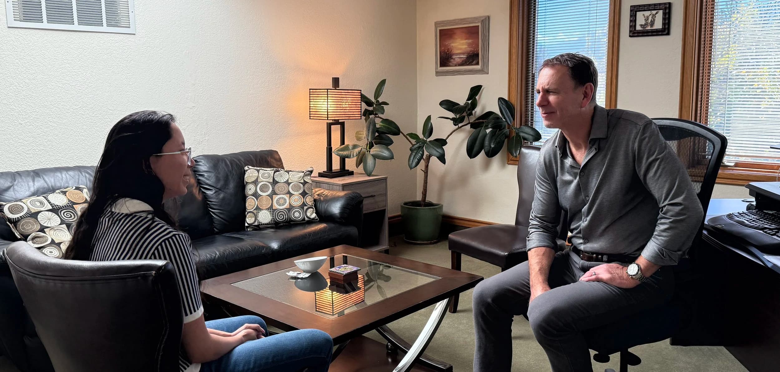 Co-founder Peter Fabish talking with a client in the Conscious Family office.