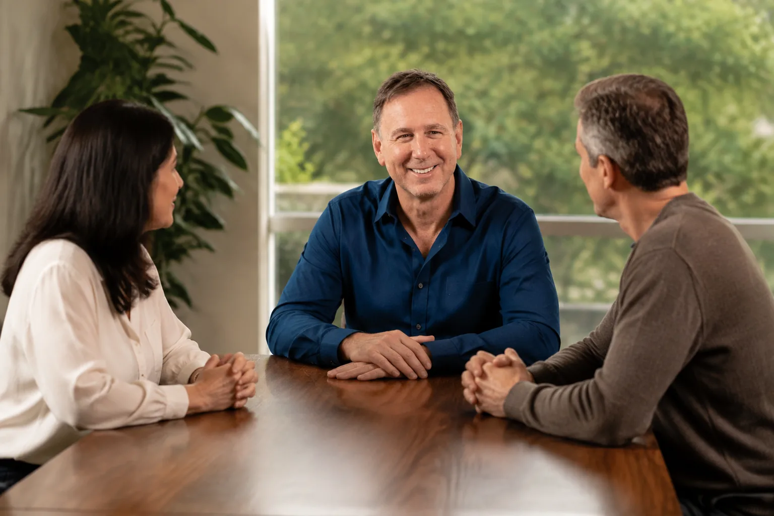 Peter Fabish meeting with a couple around a table