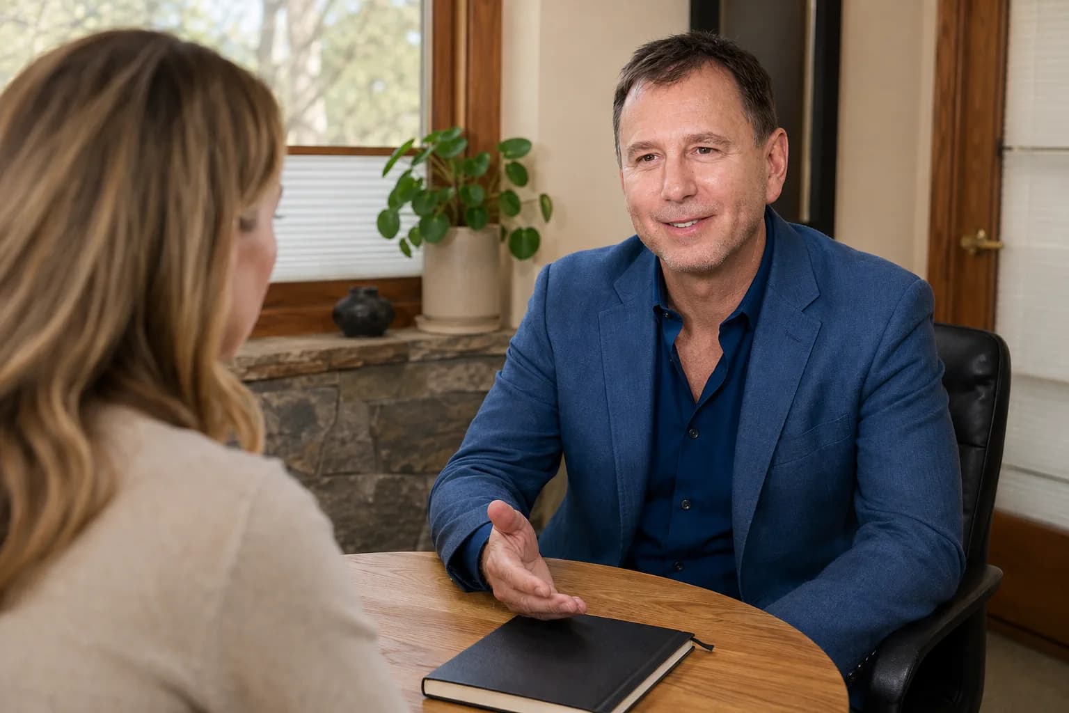 Peter Fabish talking with a client across a table in the firm's office