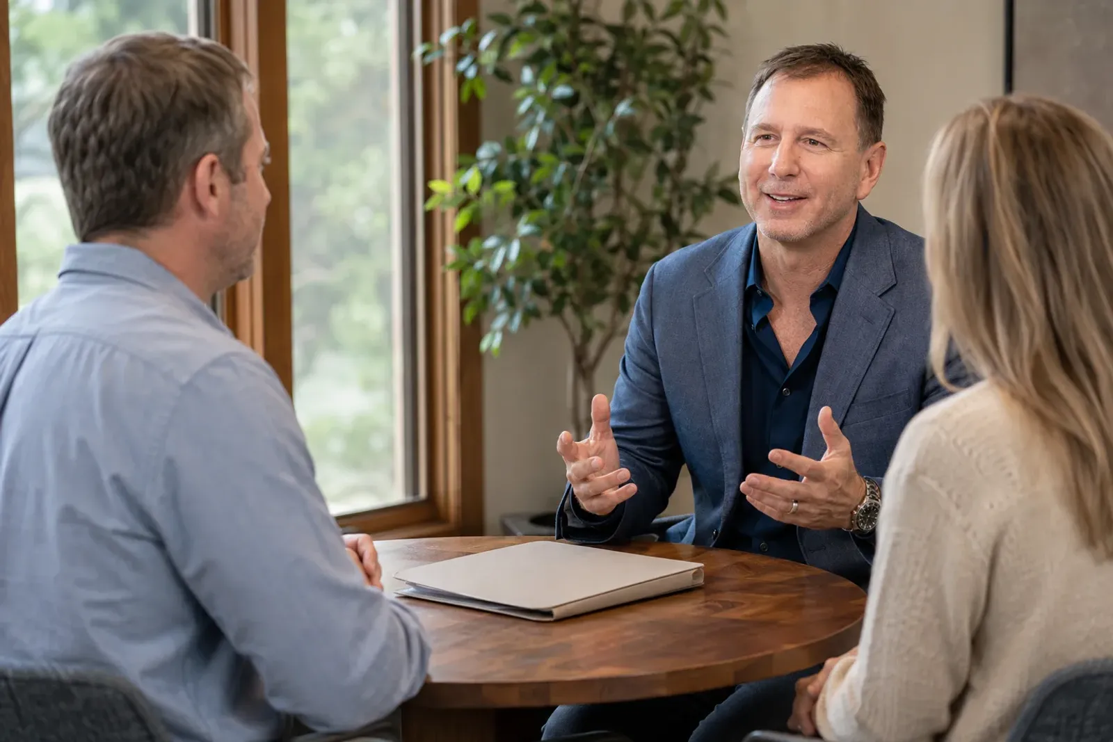 A Conscious Family attorney-mediator sitting with a couple in conversation